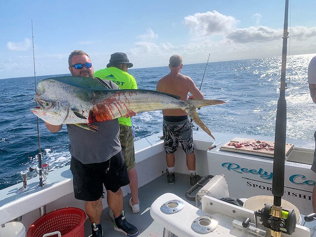 Client holding a huge fresh caught mahi on an offshore charter